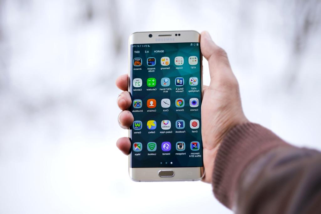 Modern mobile devices on desk with innovative interface icons
